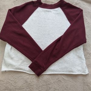 A maroon cropped baseball shirt.
